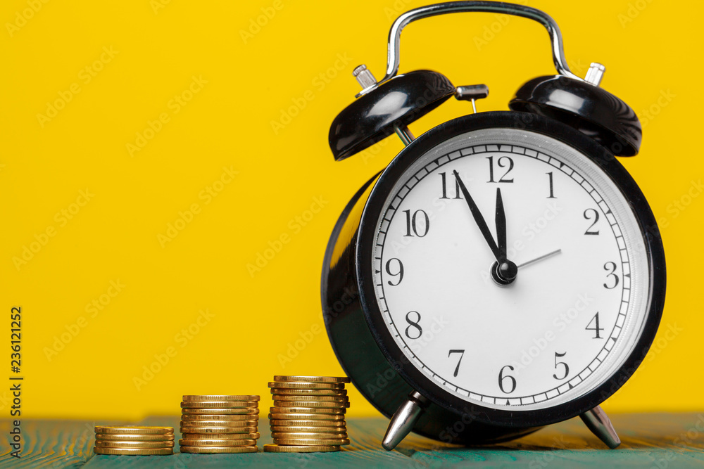 Time is money, table clock with coins Time is money, table clock with coins