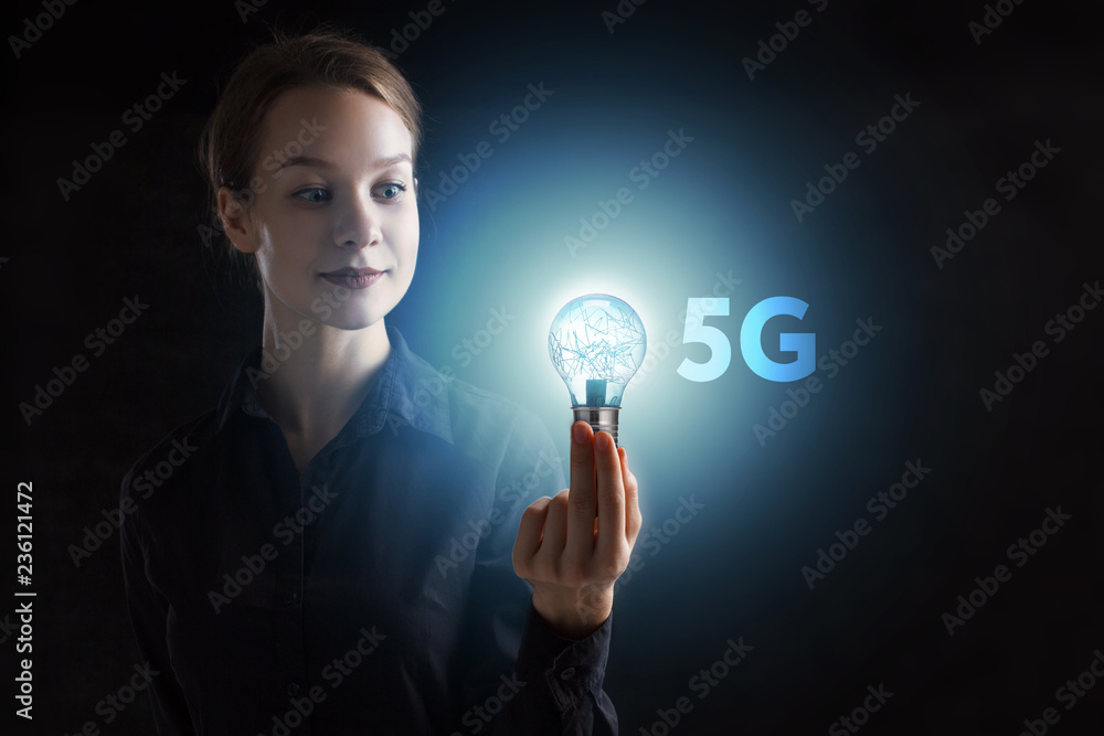 The concept of business, technology, the Internet and the network. A young entrepreneur working on a virtual screen of the future and sees the inscription: 5G The concept of business, technology, the Internet and the network. A young entrepreneur working on a virtual screen of the future and sees the inscription: 5G