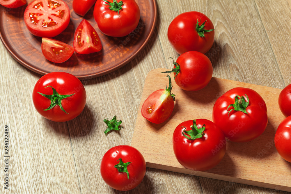 Fresh ripe tomatoes on a wooden background Fresh ripe tomatoes on a wooden background