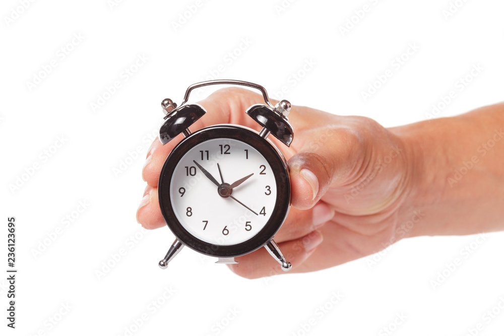 Female hand holding alarm clock on white background Female hand holding alarm clock on white background