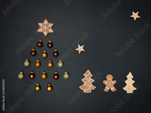 Christmas tree shaped out of different Christmas deco items, on black chalkboard © epiximages