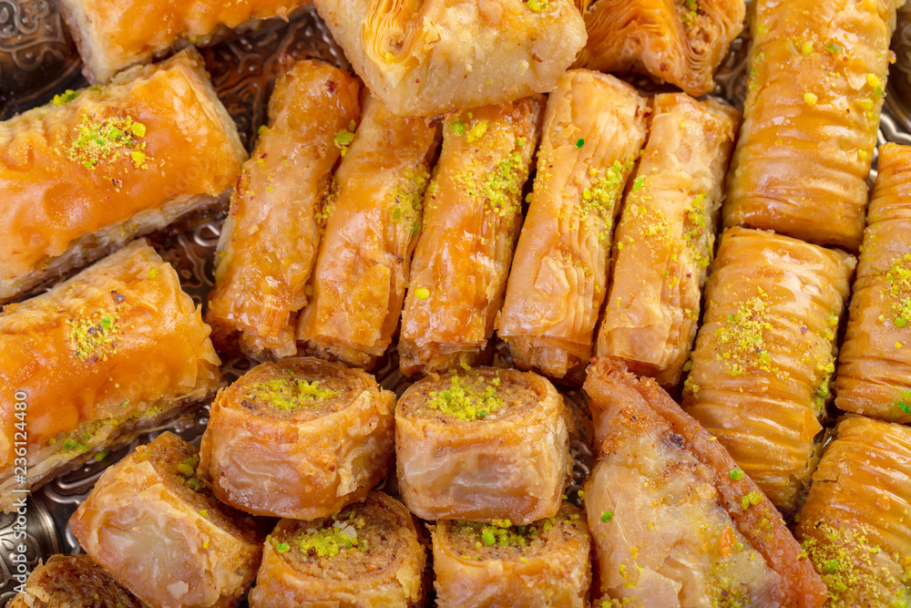 Turkish sweets baklava and metal oriental tray on wooden background Turkish sweets baklava and metal oriental tray on wooden background