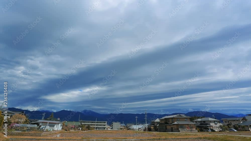Rural landscape in the Japanese province with mountains and cloudy sky in the background. Time laps. Rural landscape in the Japanese province with mountains and cloudy sky in the background. Time laps.