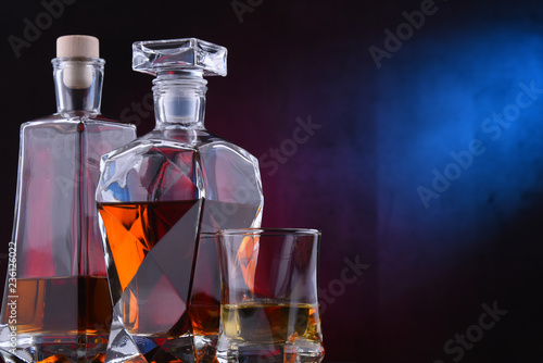 Carafe and bottles of assorted alcoholic beverages