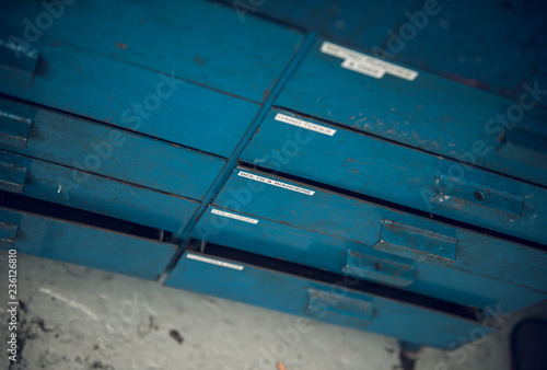 A blue smooth hard industrial machine drawer cabinet metal texture background, showing signs of scratches, usage. Beautiful industrial arty textured background perfect for type or logo