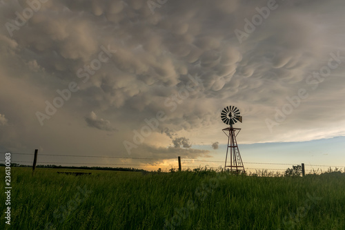 Nebraska windmill with beautiful mammatus clouds at sunset