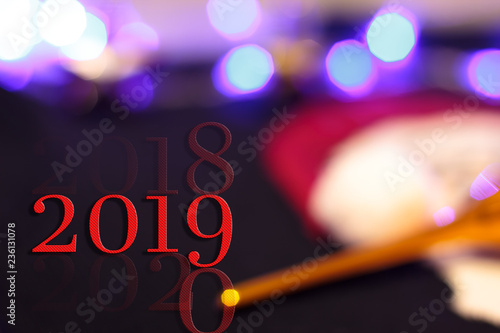New Year graphic wallpaper banner concept with creative 2019 inscription on abstract unfocused colorful celebrate background