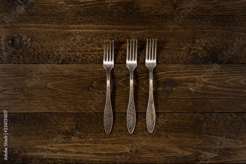 Set of vintage forks on a wooden background