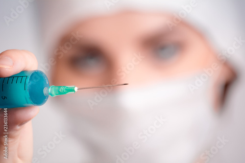 A doctor with a syringe makes an injection.