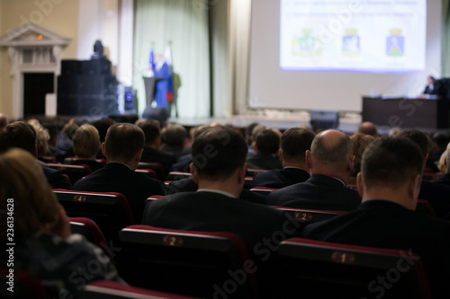 Speaker giving a talk on corporate Business Conference. Audience at the conference hall. Business and Entrepreneurship event.