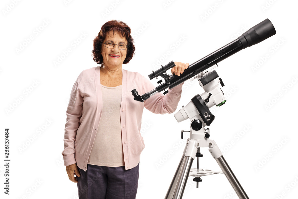 Elderly woman with a telescope looking at the camera and smiling Elderly woman with a telescope looking at the camera and smiling