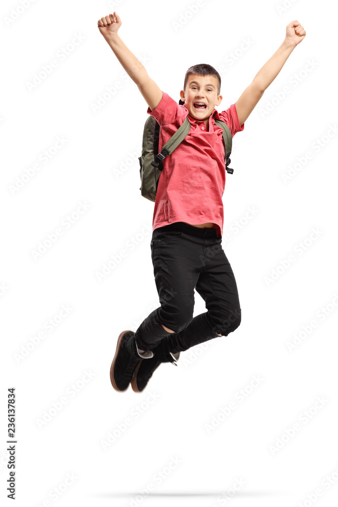 Happy and excited teenage schoolboy jumping