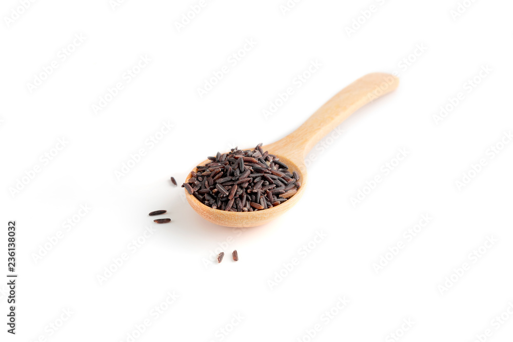Black rice with spoon on white background Black rice with spoon on white background