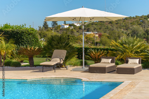 Sun bath with sun loungers and parasol. In Portugal.