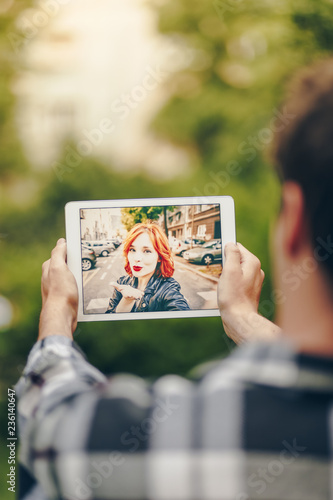 Young couple in love chatting over a video call, by using a tablet.