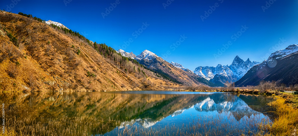 Panoramic landscape, view on beautiful autumn mountain lake Tumanly-kel, the Mist lake, located in Russia, near Dombay , in Caucasus mountains, Gonachkhir gorge