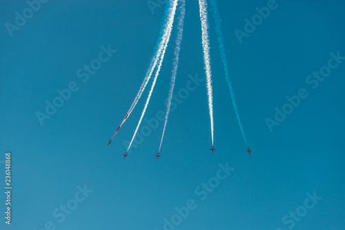 Airshow planes with multicolor trails