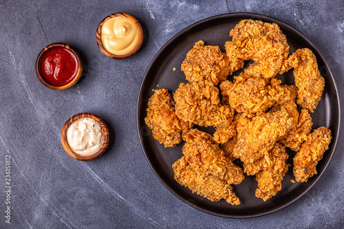 Fényképezés Fried chicken wings with various sauces.