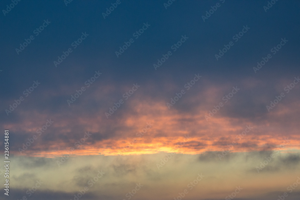 clouds at dawn. Fiery red rising sun behind the clouds. headpiece