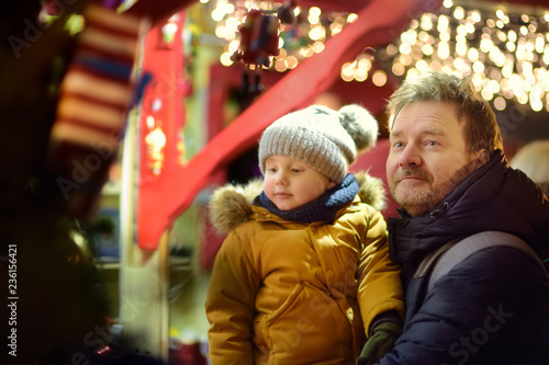 Little boy and his father having wonderful time on Xmas market
