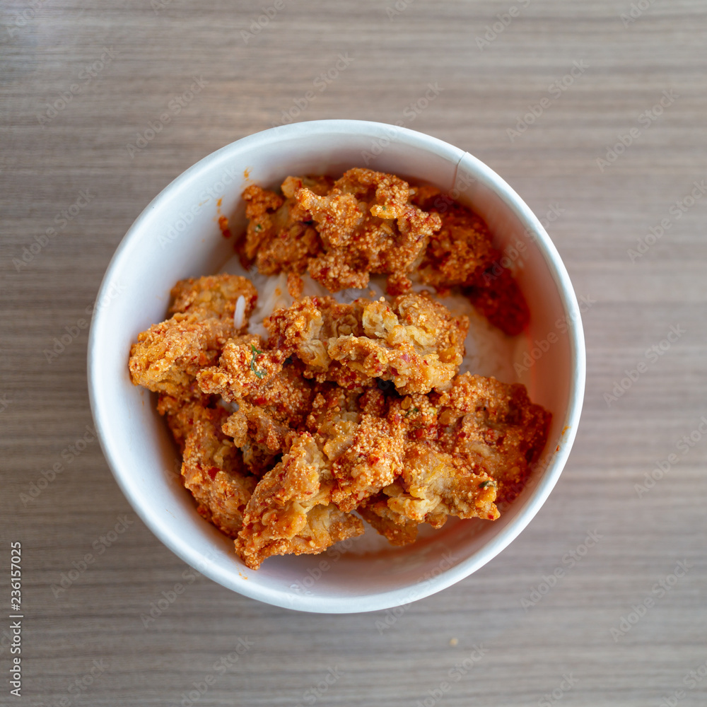 spicy pieces of chicken served with mixed rice. spicy pieces of chicken served with mixed rice.