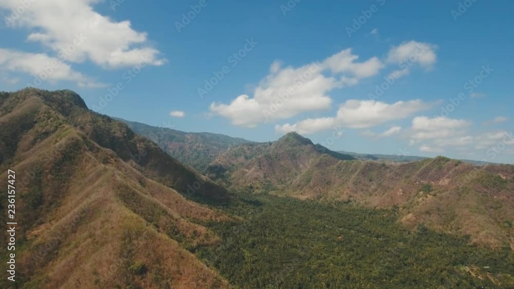 Aerial view of landscape, mountains, forest, trees with sky and clouds, Bali,Indonesia. Slopes of the mountains are covered with forest in Asia. 4K video. Travel concept. Aerial footage. Aerial view of landscape, mountains, forest, trees with sky and clouds, Bali,Indonesia. Slopes of the mountains are covered with forest in Asia. 4K video. Travel concept. Aerial footage.