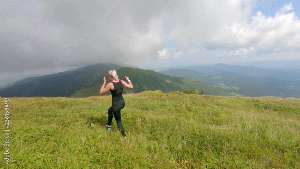 beautiful young woman walking in the mountains beautiful young woman walking in the mountains