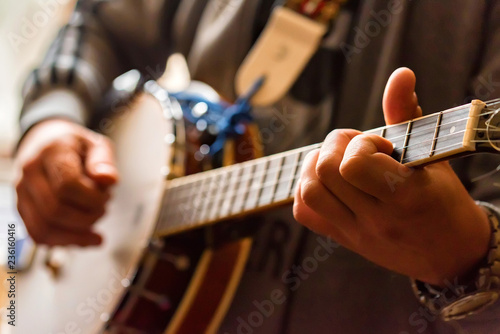 Fototapeta Close up hands of man playing banjo