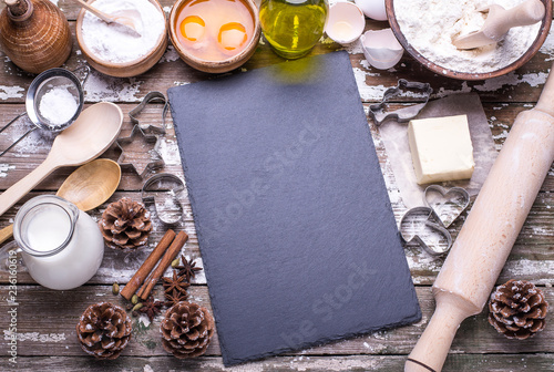 Ntural ingredients for baking homemade cookies on a wooden background with board for recipe. Flat lay. photo