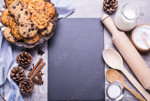 Delicious freshly baked homemade cookies and products for baking on a gray wooden table. Christmas concept. Flat lay