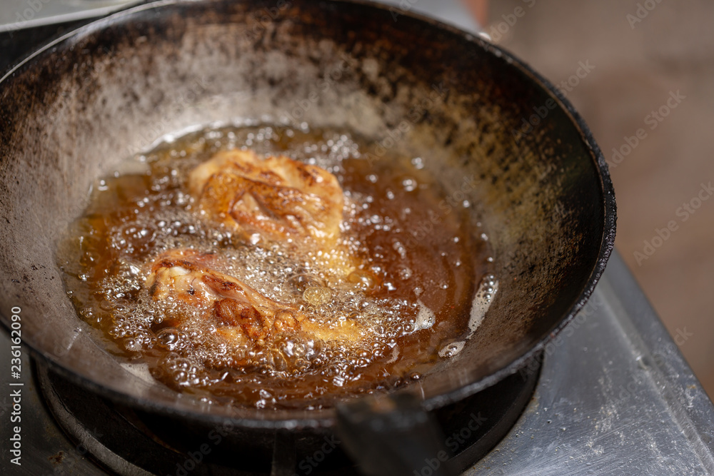 Fried chicken in hot oil and boiling in pan Fried chicken in hot oil and boiling in pan