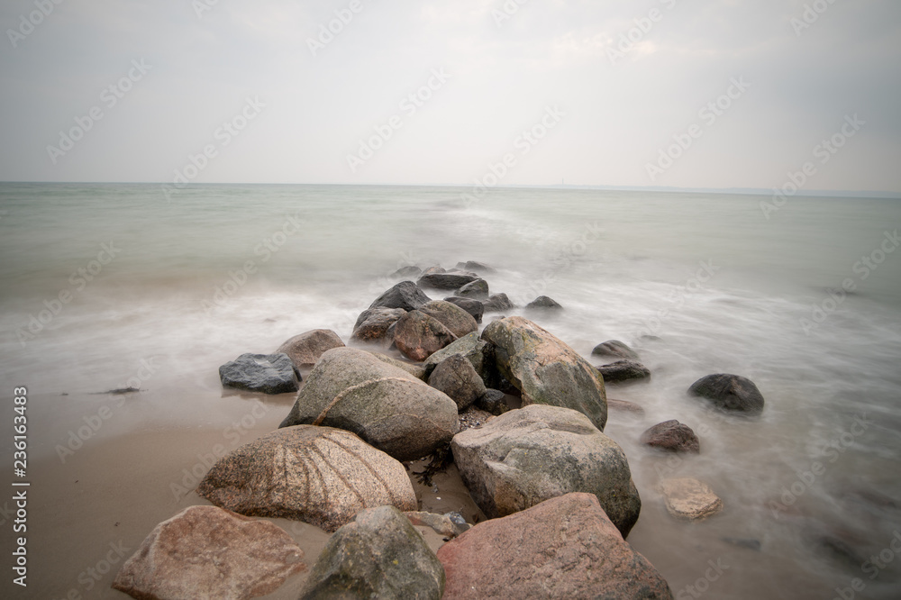 rocks on beach at sunset - longtime exposure rocks on beach at sunset - longtime exposure