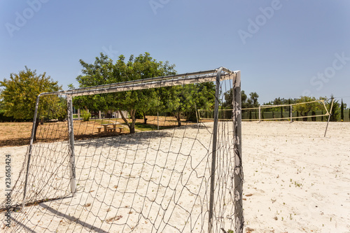 Outdoor playground for football and volleyball on the sand. © sergojpg