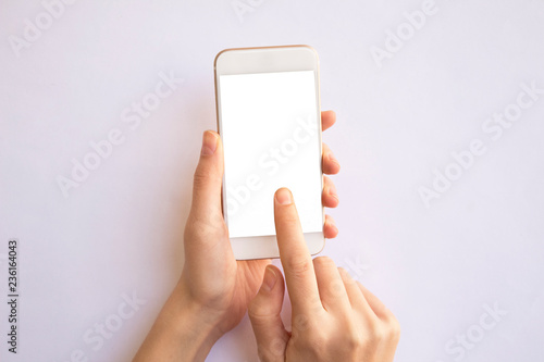 Valokuva hand holding mobile phone with isolated background.