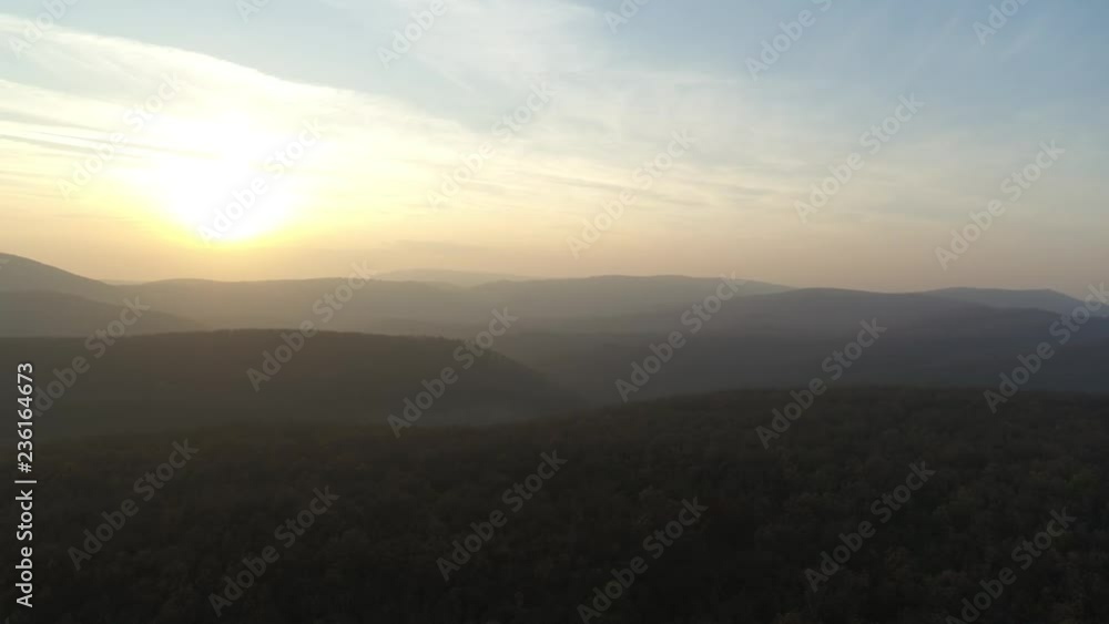 Aerial Sunset in mountains. Drone view on mountains in golden and blue hour Aerial Sunset in mountains. Drone view on mountains in golden and blue hour