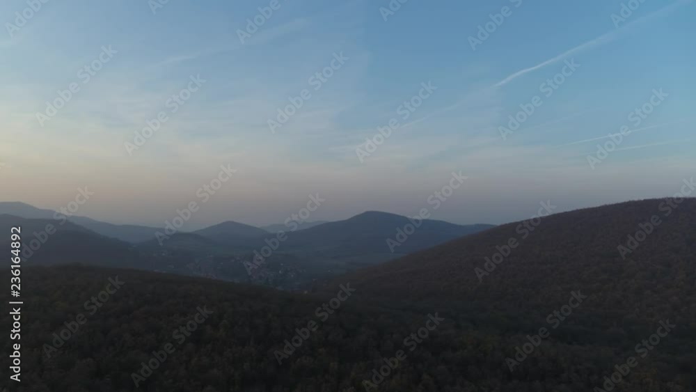 Aerial Sunset in mountains. Drone view on mountains in golden and blue hour Aerial Sunset in mountains. Drone view on mountains in golden and blue hour