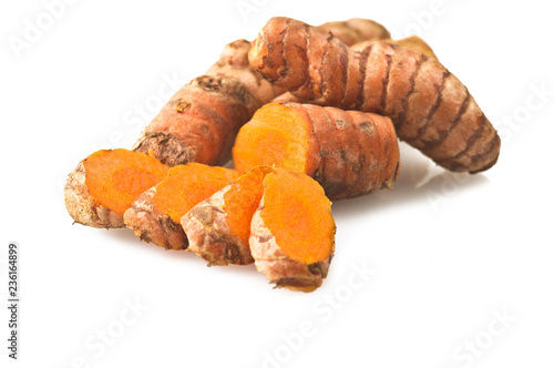 turmeric root and some slices on a white background