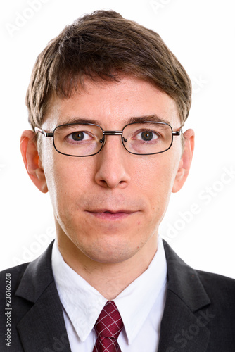 Face of businessman wearing eyeglasses and looking at camera © Ranta Images