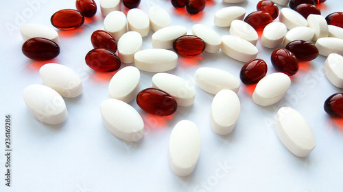 Assorted colorful pharmaceutical medicine pills, tablets and capsules on white background. Pharmacy theme, health care, drug prescription for treatment medication and pharmaceutical medicament