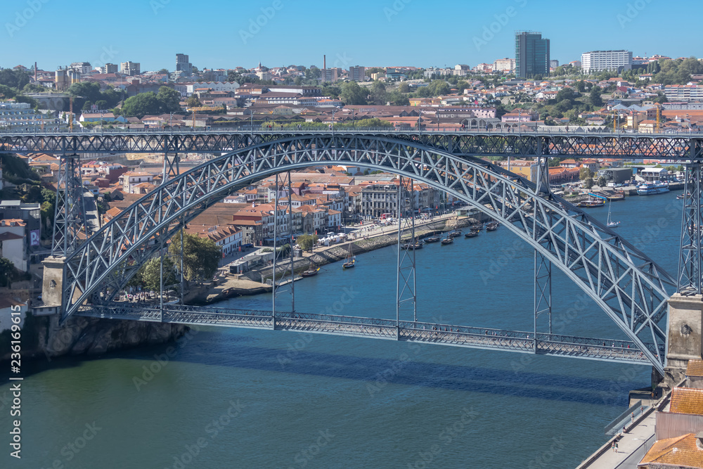 View of D. Luis bridge, Douro river with boats and Gaia city as background View of D. Luis bridge, Douro river with boats and Gaia city as background