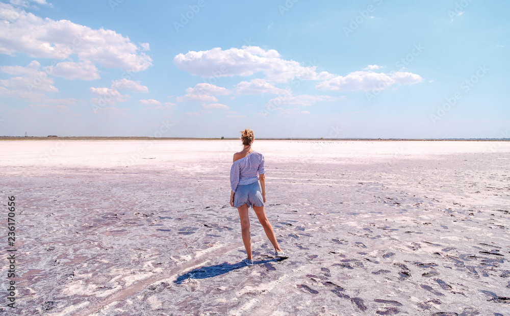 A girl on a pink salty lake