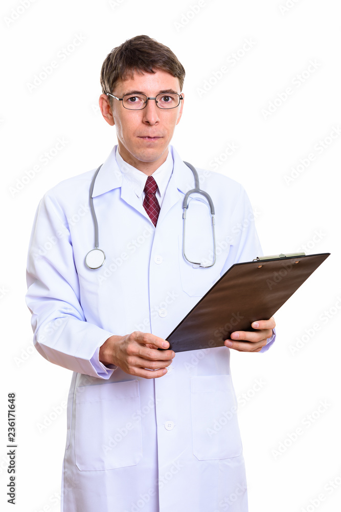 Studio shot of man doctor holding clipboard Studio shot of man doctor holding clipboard