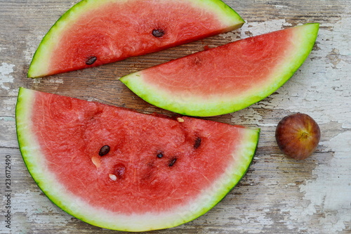 slices of watermelon on a wooden table. photo