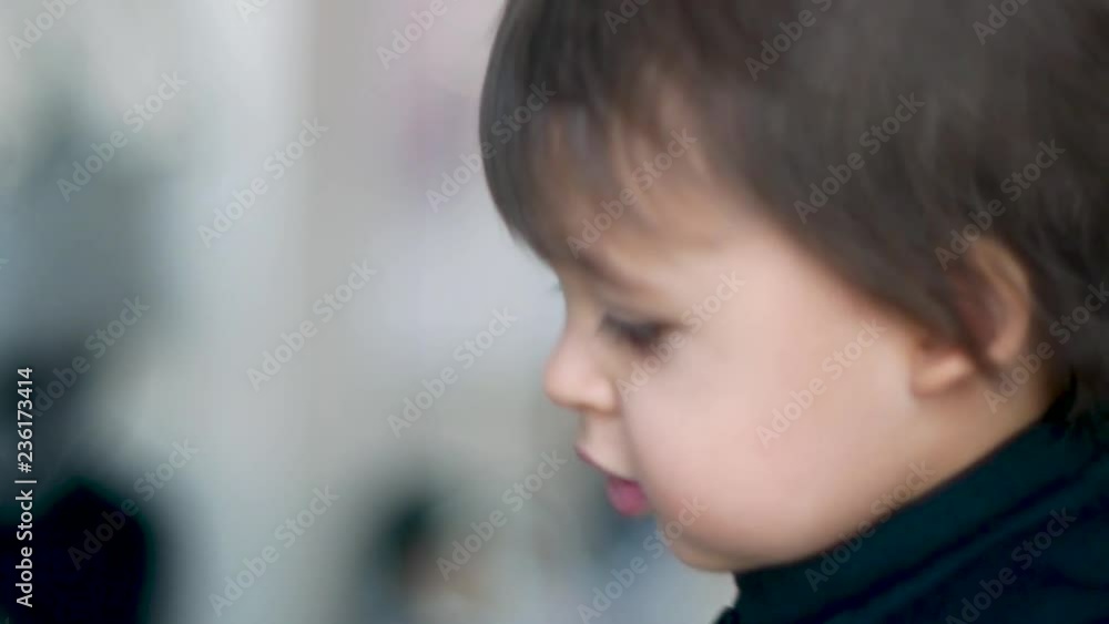 closeup portrait of a child boy in a black jumpsuit closeup portrait of a child boy in a black jumpsuit