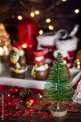 Christmas background with decorations on wooden table with warm lighting.