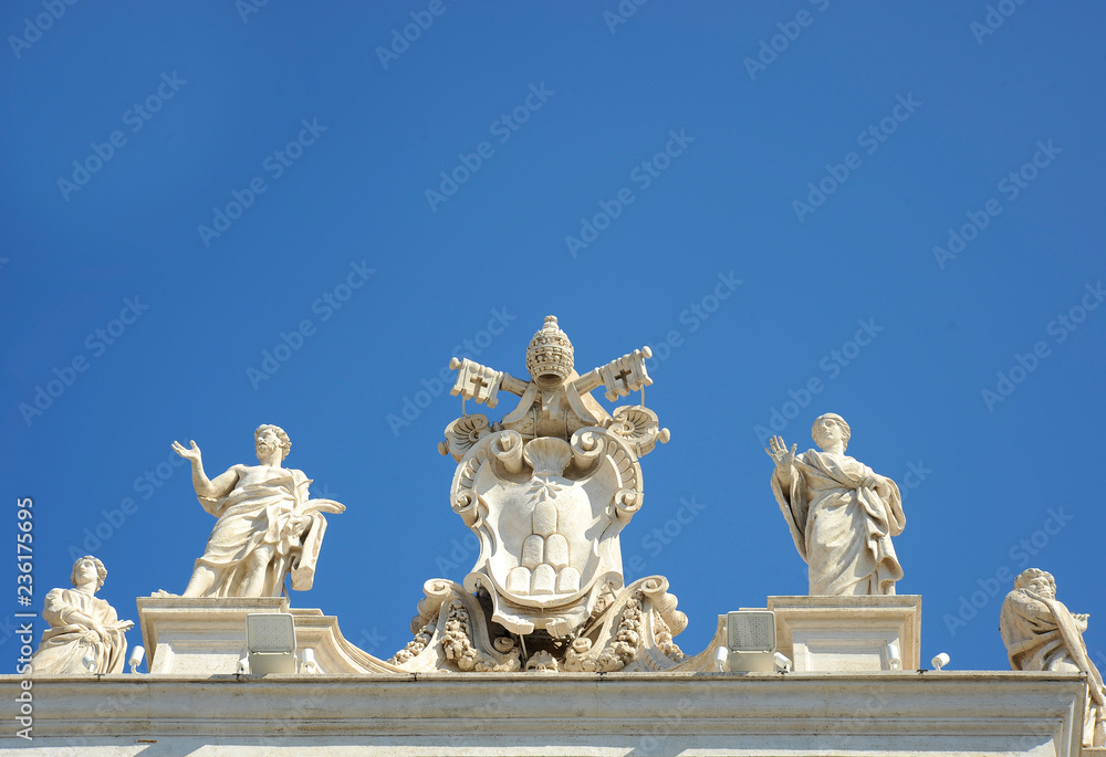 Detail from baroque Saint Peter's colonnade with beautiful statues of saints and Pope Alexander VII coat of arms. Vatican City (Rome, Italy)