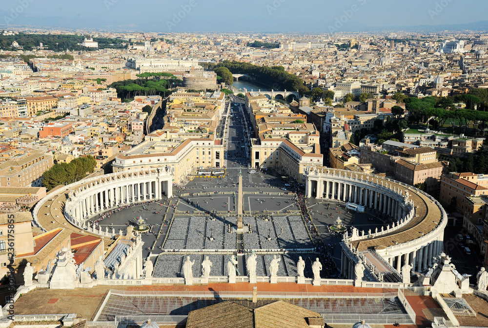 Famous Saint Peter's Square in Vatican and aerial view of the city. Vatican city (Rome, Italy).