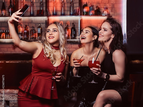 Cheerful female friends resting in the nightclub