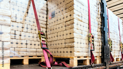  There is a loading to the truck trailer .  fastening of freight in the trailer .   transportation of freight Europe . industrial infrastructure . to fix freight .  Cargo container . 