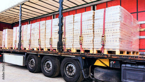  There is a loading to the truck trailer . fastening of freight in the trailer . transportation of freight Europe . industrial infrastructure . to fix freight . Cargo container . 